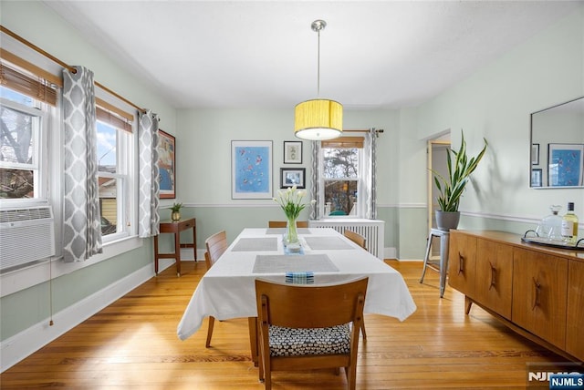 dining space with a healthy amount of sunlight, baseboards, and light wood finished floors