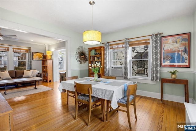 dining room with baseboards, light wood finished floors, and ceiling fan