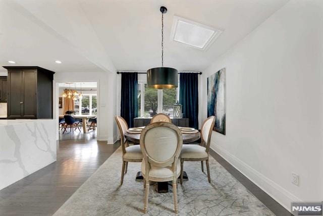 dining area featuring recessed lighting, baseboards, an inviting chandelier, and wood finished floors