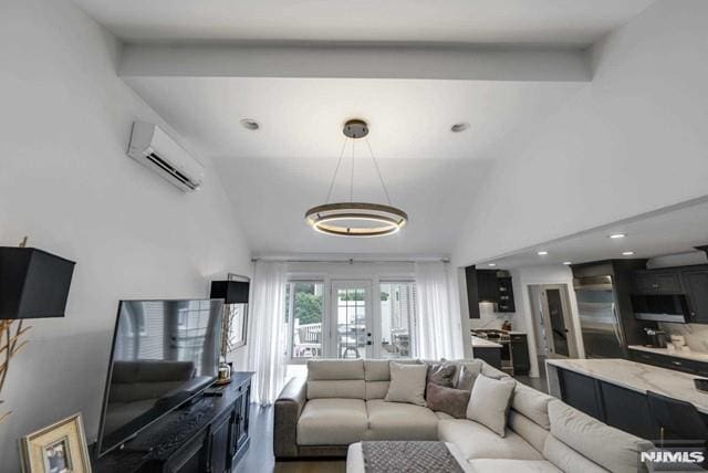 living area with wood finished floors, an inviting chandelier, recessed lighting, french doors, and a wall mounted air conditioner