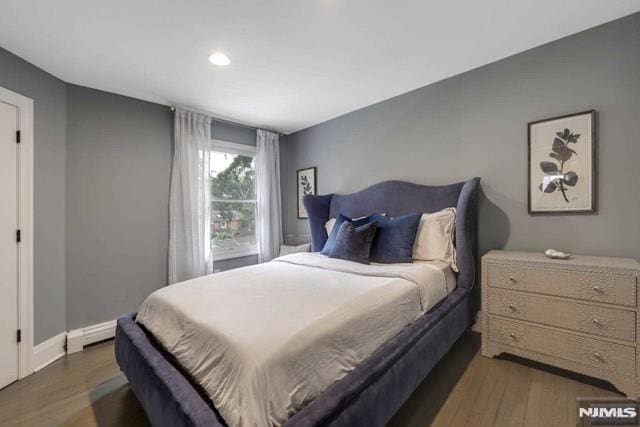 bedroom featuring wood finished floors and baseboards