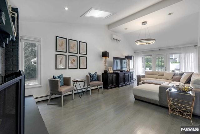 living room with a baseboard heating unit, an AC wall unit, a fireplace, wood finished floors, and high vaulted ceiling