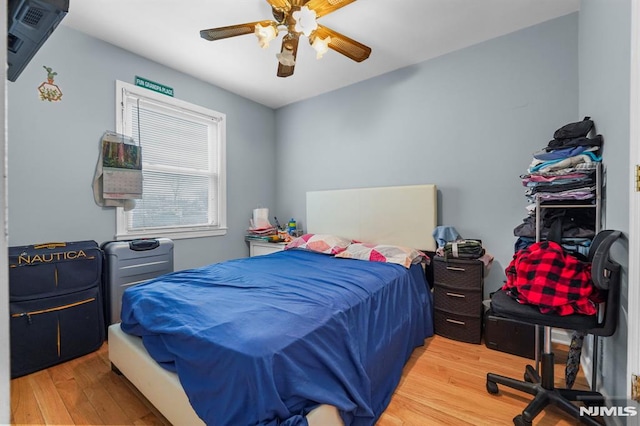 bedroom with a ceiling fan and wood finished floors