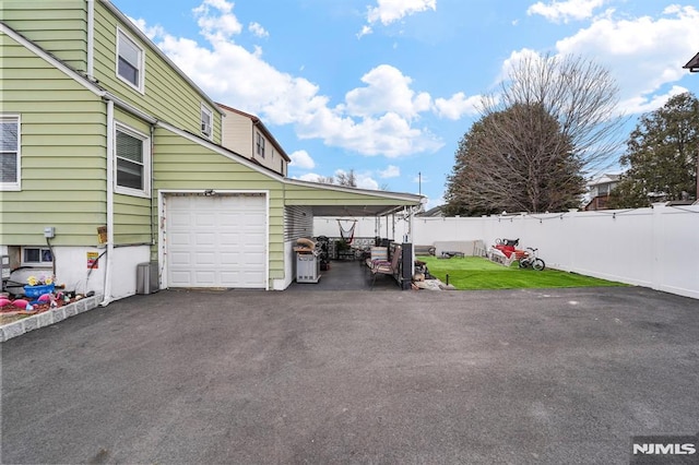 exterior space with driveway and fence