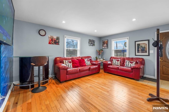 living room featuring hardwood / wood-style flooring, baseboards, and recessed lighting