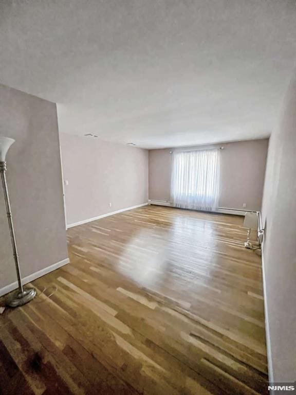 interior space with baseboards and wood finished floors