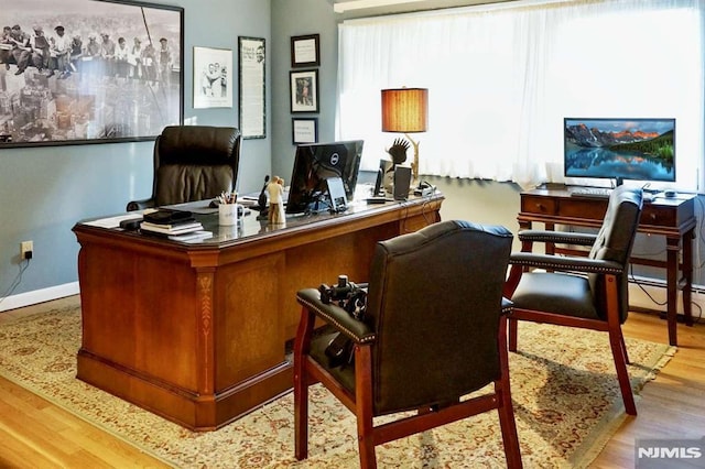 office area featuring wood finished floors and baseboards