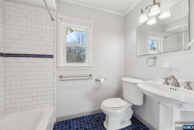 bathroom featuring baseboards, ornamental molding, toilet, and a healthy amount of sunlight