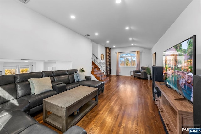 living area featuring stairs, vaulted ceiling, wood finished floors, and recessed lighting