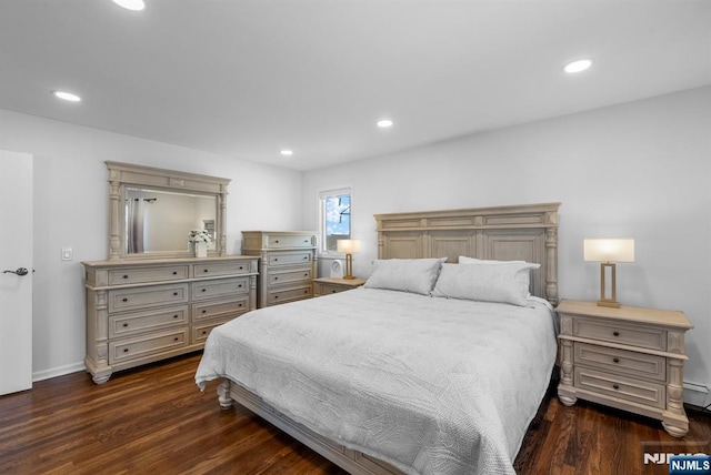 bedroom with a baseboard radiator, baseboards, dark wood-type flooring, and recessed lighting