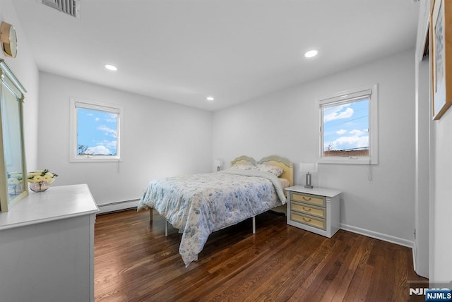 bedroom with dark wood-style floors, a baseboard radiator, visible vents, and recessed lighting