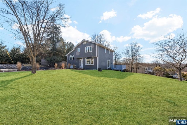 rear view of house featuring a lawn