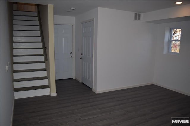 198 Wallace St, Orange, NJ 07050 - foyer entrance with dark wood-type flooring, stairs, and baseboards