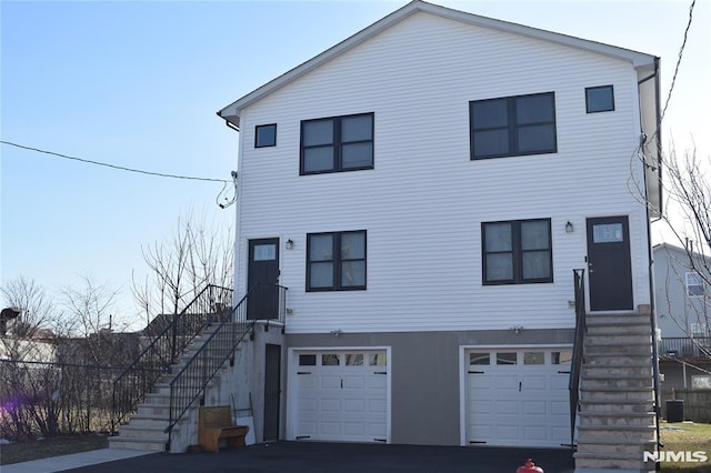 198 Wallace St, Orange, NJ 07050 - view of front of home with stairway, central AC unit, entry steps, and a garage