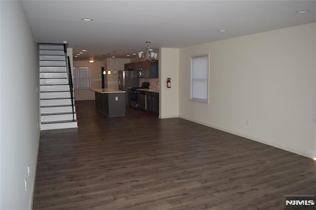 198 Wallace St, Orange, NJ 07050 - unfurnished living room featuring stairway, dark wood-style floors, baseboards, recessed lighting, and a chandelier