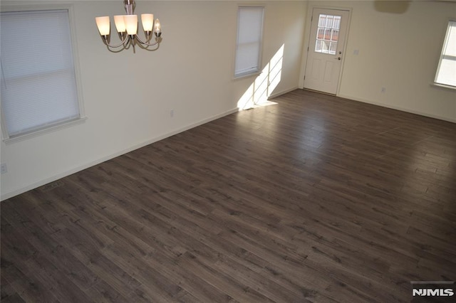 198 Wallace St, Orange, NJ 07050 - spare room featuring baseboards, an inviting chandelier, and dark wood-style floors