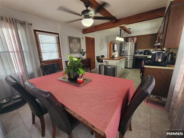 dining area featuring ceiling fan and beam ceiling