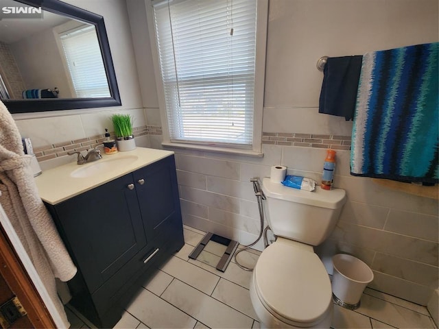 bathroom featuring tile walls, vanity, toilet, and tile patterned floors