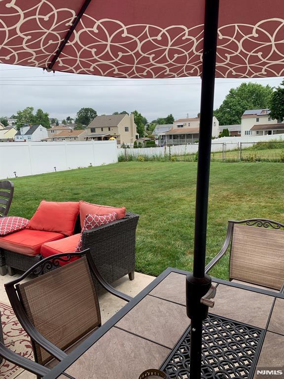 view of patio / terrace featuring a residential view and fence