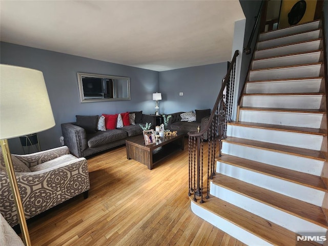 living room with stairs and hardwood / wood-style floors