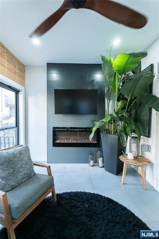 tiled living area with a large fireplace