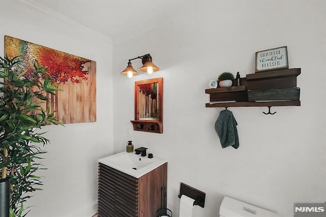 bathroom featuring toilet and vanity