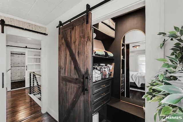 interior space with dark wood-style floors and a barn door