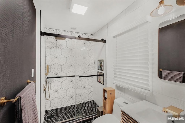 bathroom with a shower stall and toilet