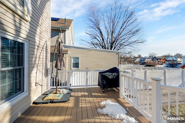 wooden deck with a grill and fence