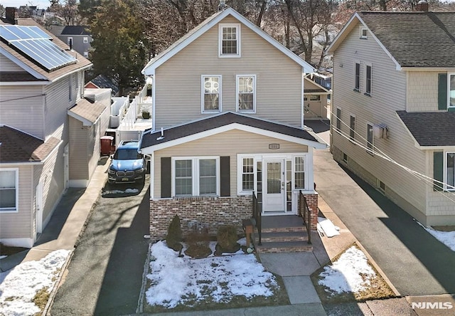 view of front of house featuring aphalt driveway and brick siding