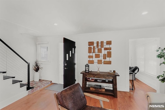 foyer featuring stairway, wood finished floors, and recessed lighting