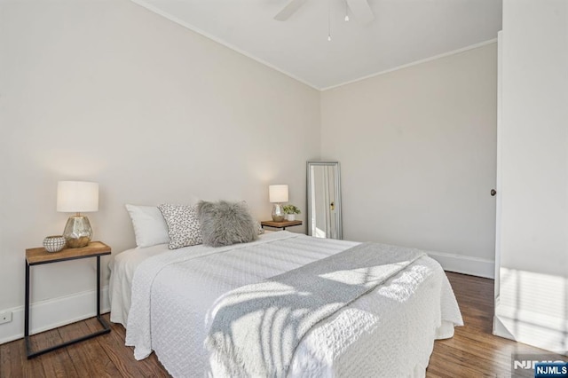 bedroom featuring baseboards, ornamental molding, ceiling fan, and wood finished floors