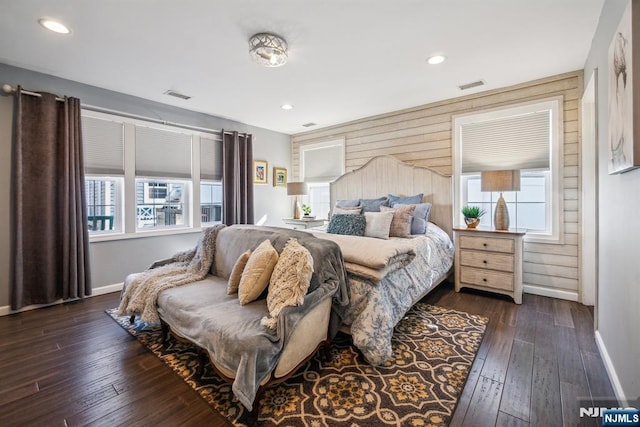 bedroom featuring visible vents, multiple windows, and dark wood finished floors