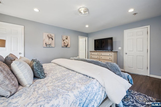 bedroom with recessed lighting, wood finished floors, and baseboards