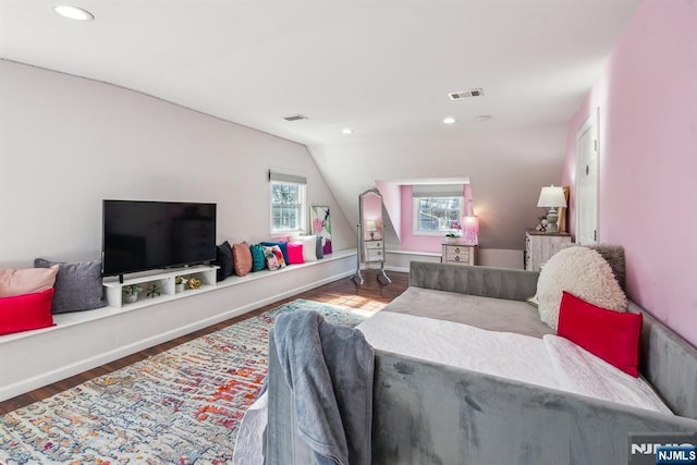 living area featuring lofted ceiling, recessed lighting, wood finished floors, and visible vents