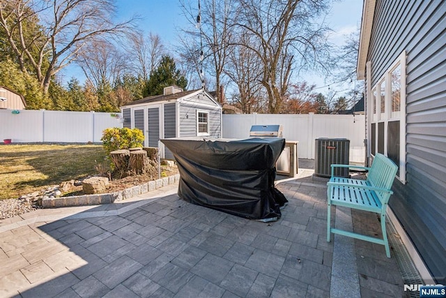 view of patio with a fenced backyard, central AC, and an outdoor structure