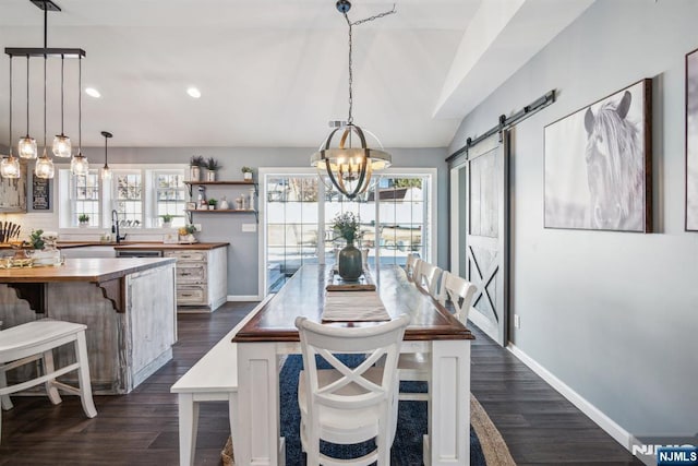 dining area featuring baseboards, an inviting chandelier, recessed lighting, dark wood-type flooring, and a barn door