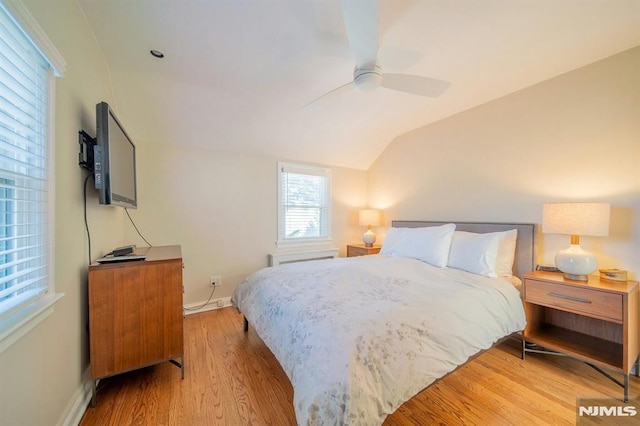 bedroom with vaulted ceiling, ceiling fan, wood finished floors, and baseboards