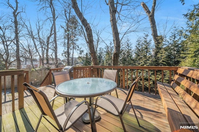 wooden terrace featuring outdoor dining area