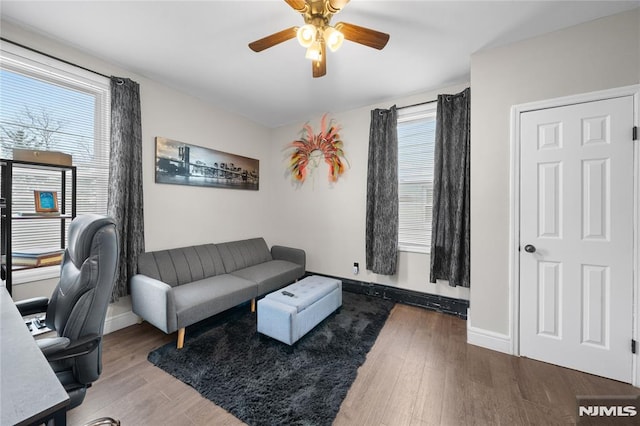 home office with ceiling fan, baseboards, and wood finished floors