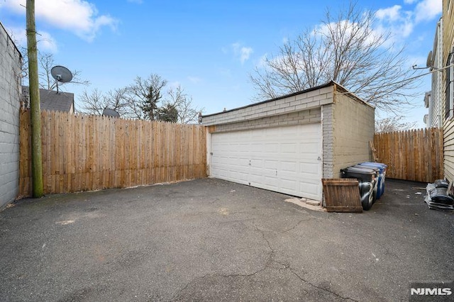 detached garage featuring fence