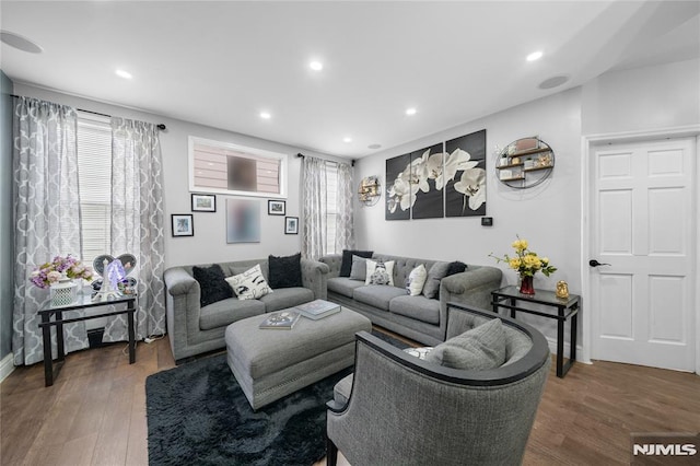 living room with plenty of natural light, wood finished floors, and recessed lighting