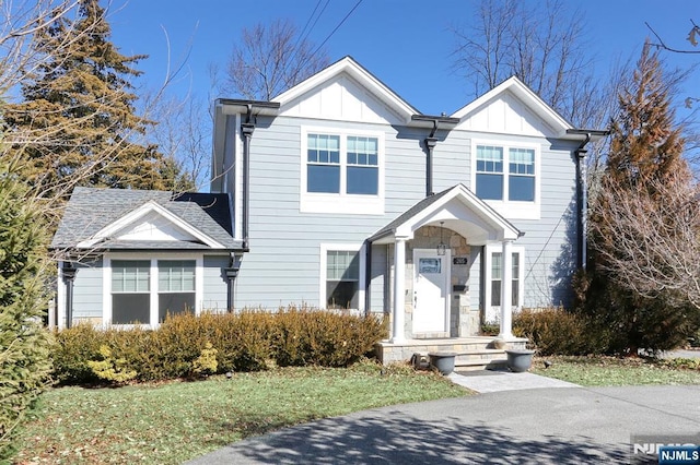 view of front of home featuring a shingled roof and board and batten siding