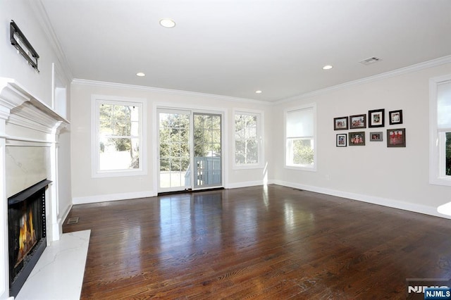 unfurnished living room featuring ornamental molding, dark wood-style flooring, visible vents, and a premium fireplace