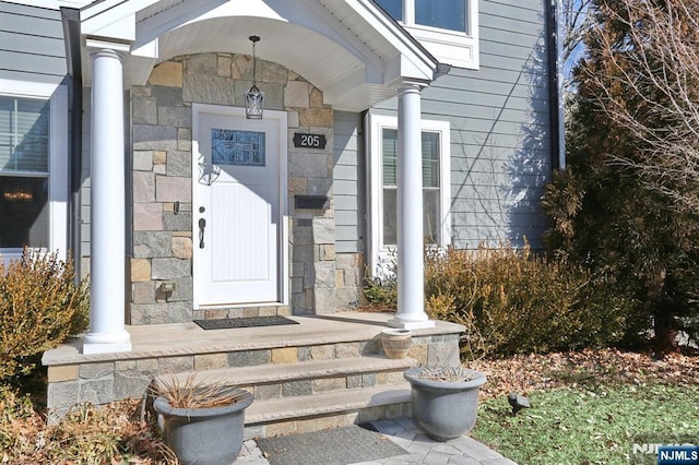 doorway to property with stone siding