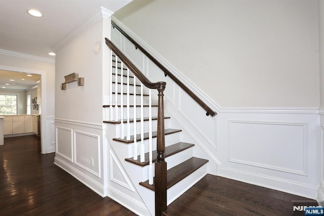 stairs featuring a wainscoted wall, crown molding, recessed lighting, a decorative wall, and wood finished floors