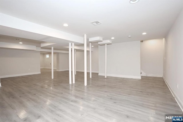 basement with baseboards, light wood finished floors, and recessed lighting