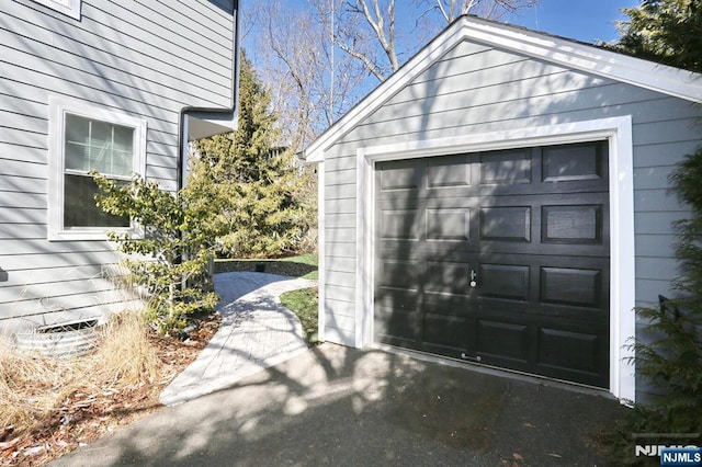 detached garage featuring driveway