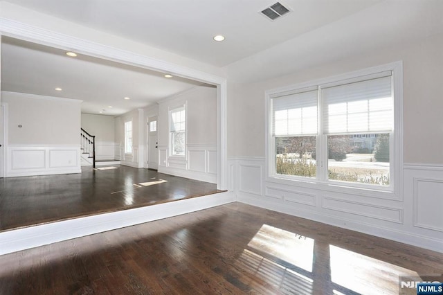 entryway featuring recessed lighting, a wainscoted wall, wood finished floors, visible vents, and stairs