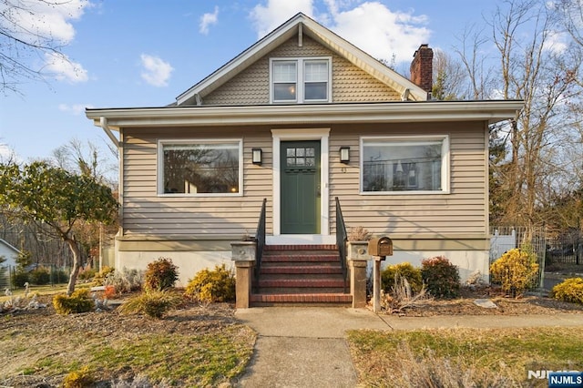 bungalow-style house with a chimney